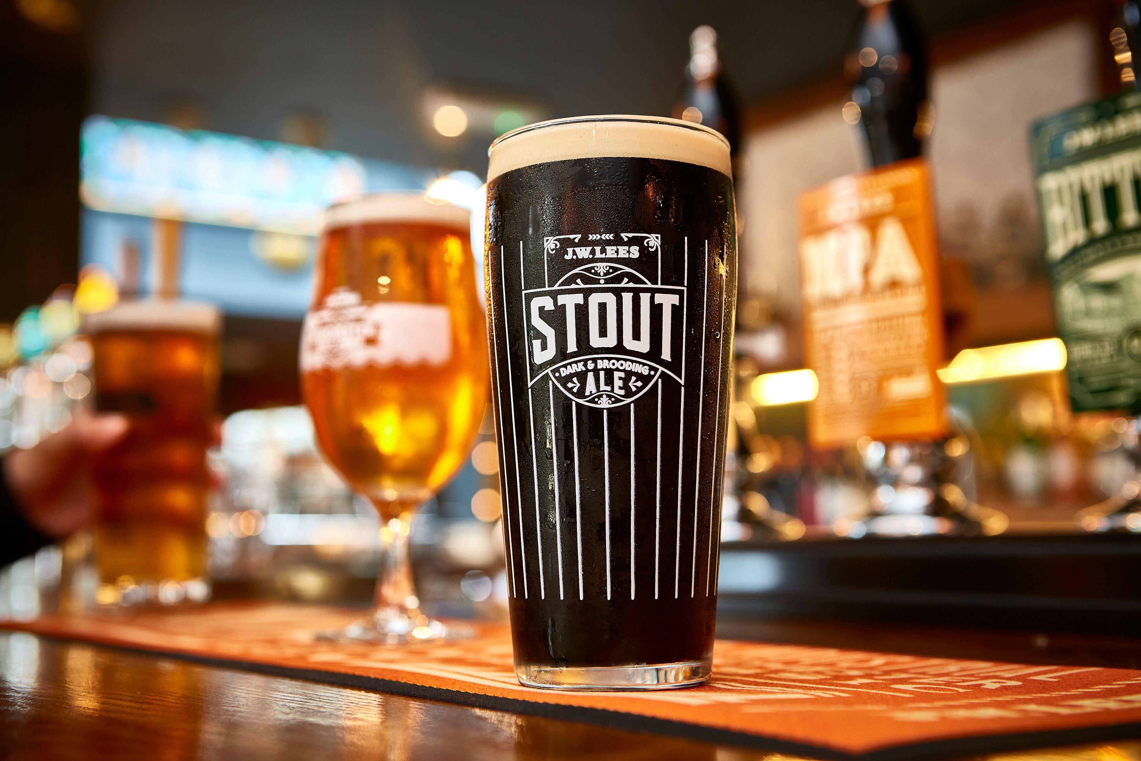 Stout-glass-on-bar-with-other-core-beers